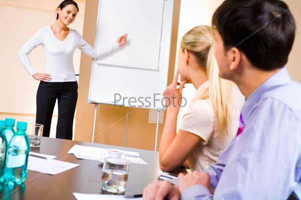 Businesswoman doing presentation on whiteboard at seminar
