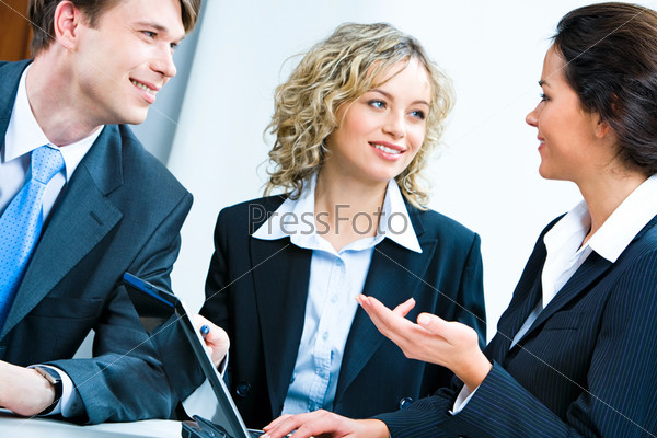 Business woman telling her plan of work to co-workers at meeting