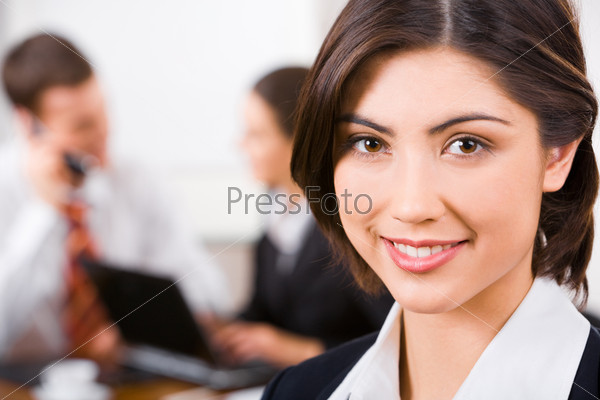 Face of confident beautiful secretary on the background of people