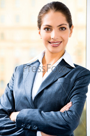 Portrait of attractive business woman in suit folding her arms