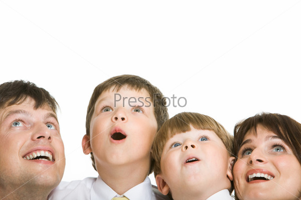 Photo of surprised family members looking upwards with excitement
