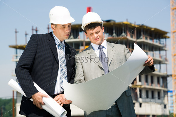Image of architect and worker looking at architectural project