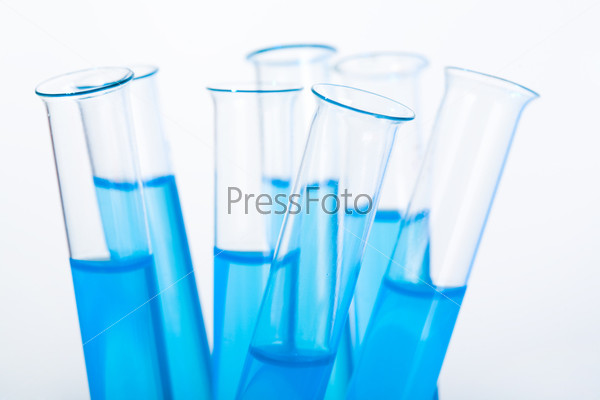 Image of several medical flasks with blue water on a white background