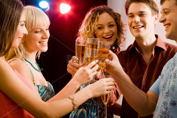 Portrait of five happy people holding glasses of champagne making a toast, stock photo