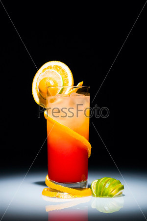 Tequila sunrise cocktail with slice of  orange and lime