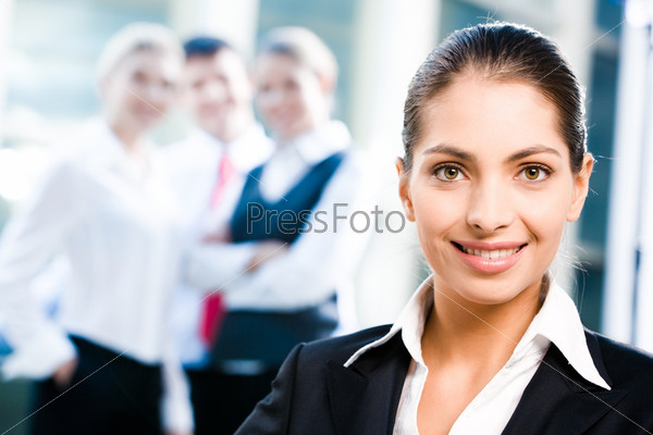 Face of female leader on the background of her business team