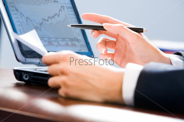 Image of white collar worker’s hands holding a pen and paper
