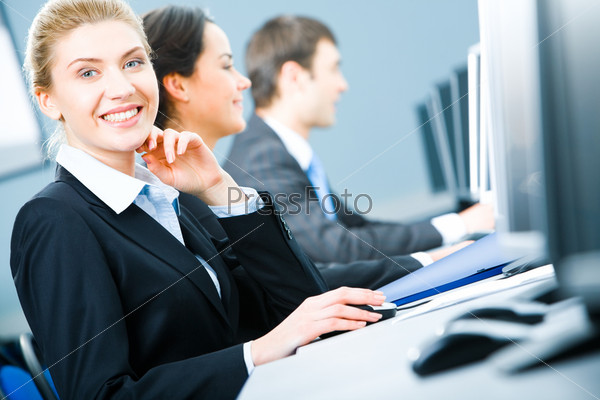 Portrait of friendly smiling woman looking at camera during business training