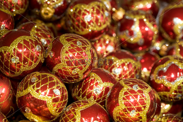 Image of bright glittering toy balls of red color with golden and silver decor