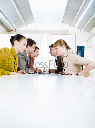 Photo of business people staring at each other with aggressive expression