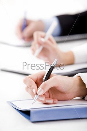 Conceptual image of human hands writing on the paper