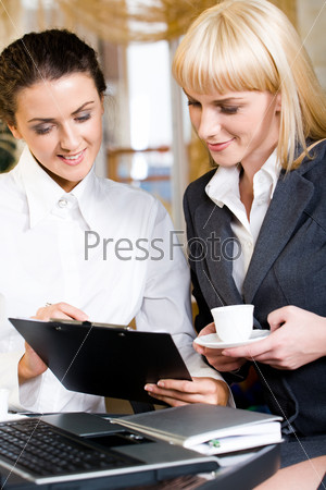 Portrait of two strong women interacting at business meeting