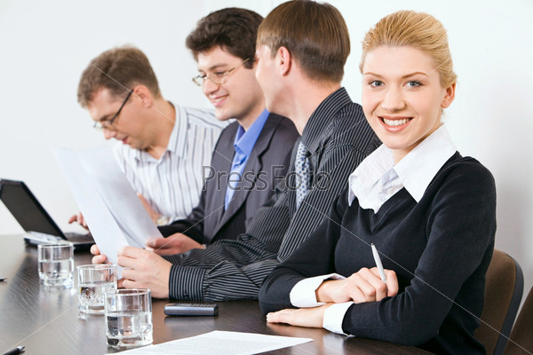 Portrait of confident people sitting at the table at business meeting