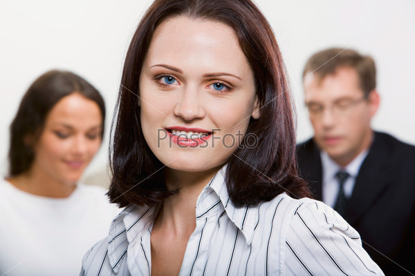 Female leader on the background of her business team, stock photo