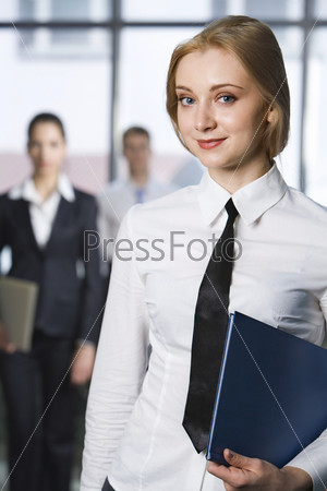 Portrait of smart smiling business woman holding the folders