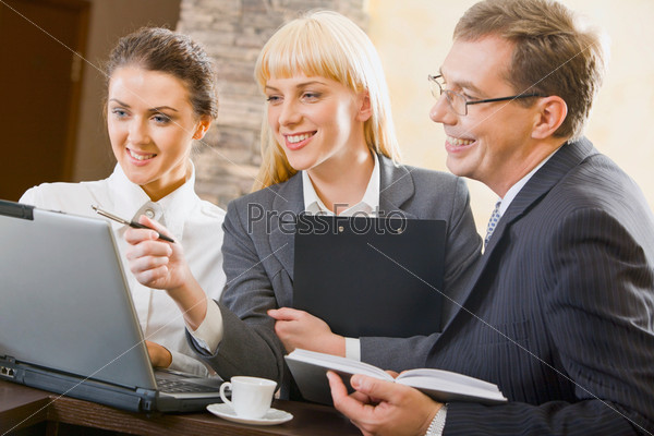 Confident woman is showing creative project to her successful friends