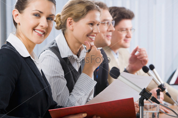 Portrait of successful smiling young woman at a seminar