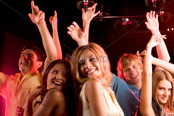 Image of happy young people having fun at disco