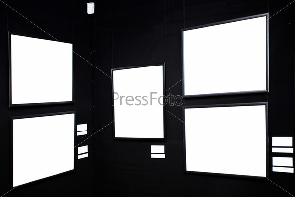 Black wall in museum with frames