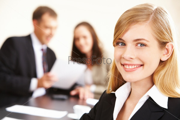 Portrait of successful business lady looking at camera in working environment