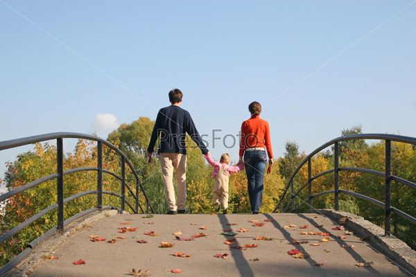 behind family with baby on autumn bridge