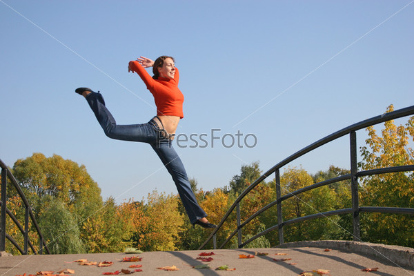 jump girl on autumn bridge