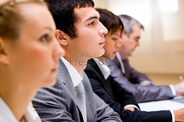 Image of businessman among his colleagues at conference 