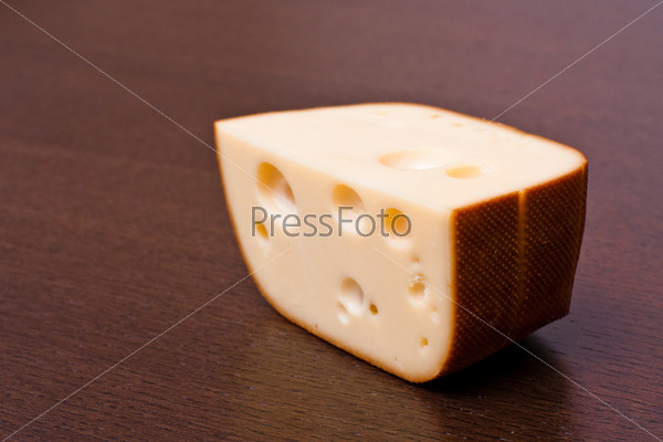 A brick of smoked cheese on the table