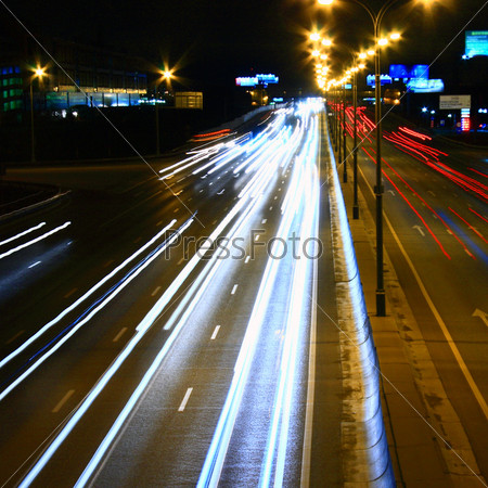Night highway with car traffic and blurry lights – long exposure – light lines – showing speed