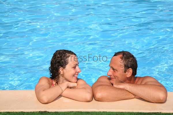 Woman and man at the pool board