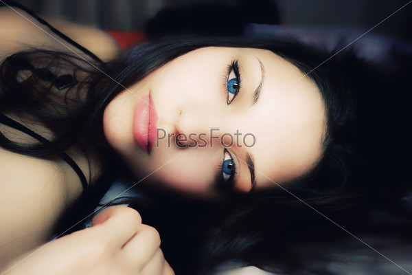 beautiful  lying woman with dark blue eyes