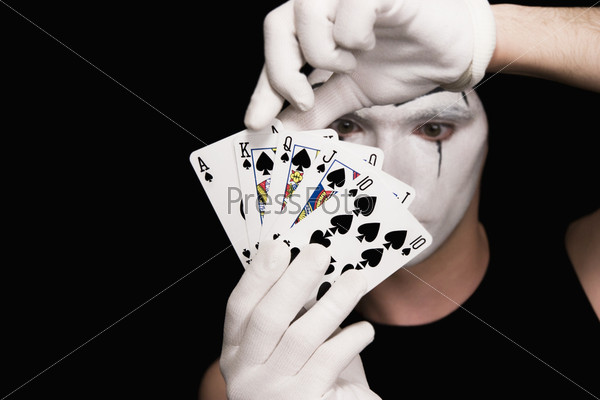 Portrait of  mime with playing cards on  black background