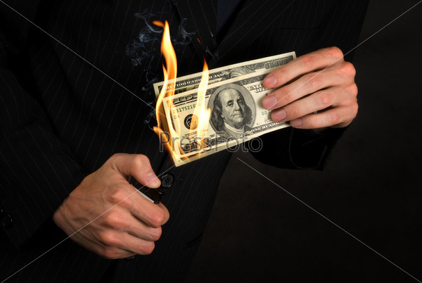 Flaming money in hand