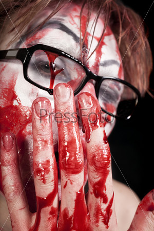 Portrait of  mime in glasses with blood on face close up