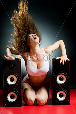 young beautiful girl listening music with pleasure