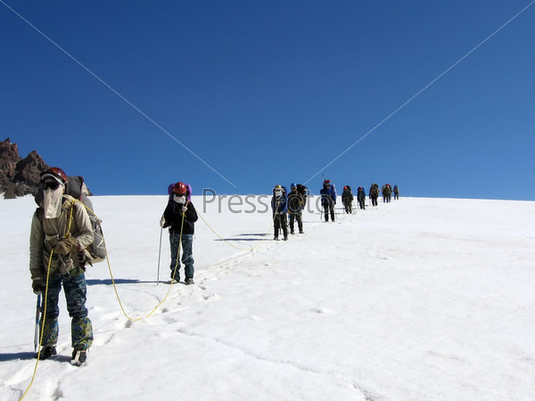 Climbers with rope on a snow glacier