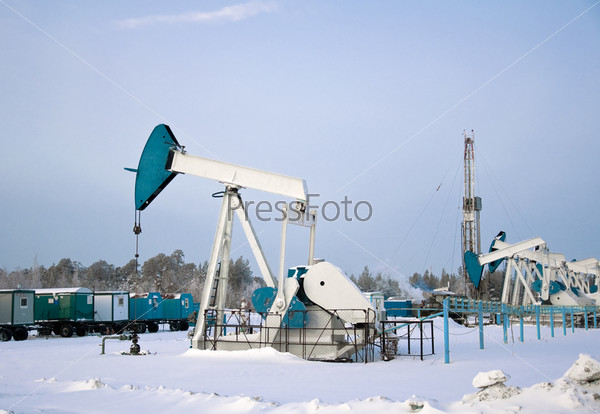 oil pumps and drilling rig in the winter. Russia, Western Siberia