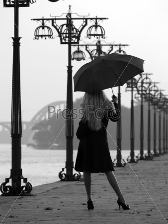 Beautiful blonde lady holding lantern on promenade