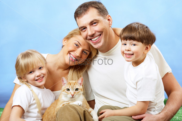 Portrait of affectionate family members looking at camera on blue background