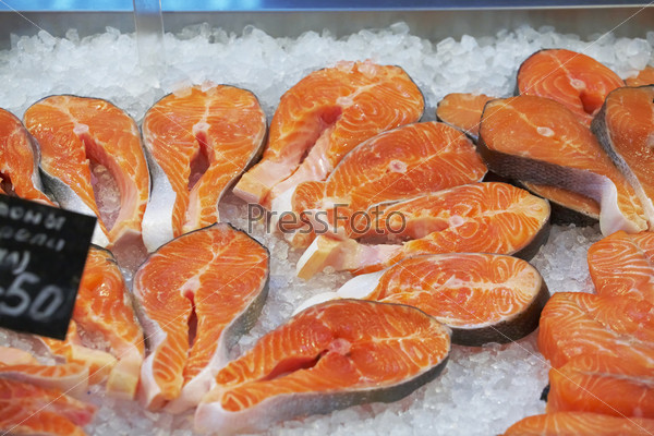 The big pieces of red fish on ice in the fish market