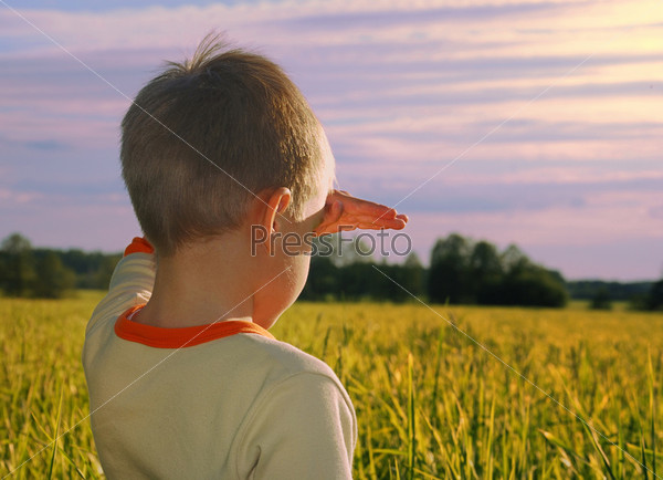 Happy young boy looking horizon in sundo