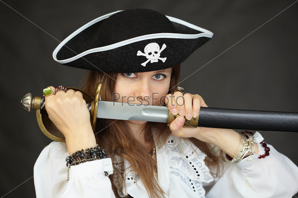 Woman pirate, demonstrates his sword, taking out from the sheath