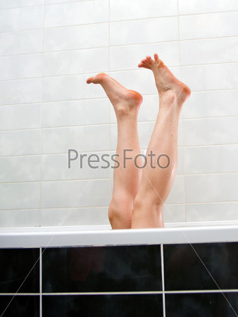 Legs of woman lying in a bath