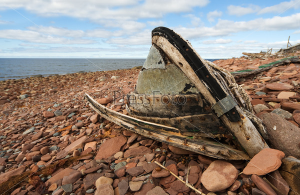 The old, broken boat on seacoast