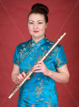 Japanese girl with flute on the red background