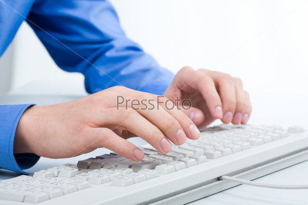 Photo of businessman?s hands over white computer keyboard