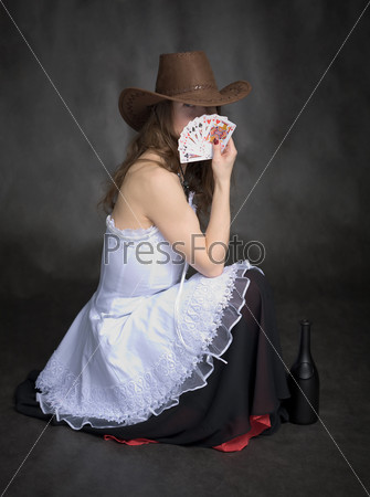 Girl with a playing-cards in hand on black