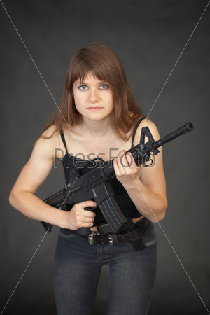 The beautiful young sexual woman with a rifle