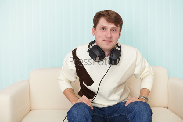 The man with the head-phones on a sofa