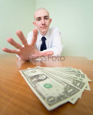 Man reaches for a batch of money
